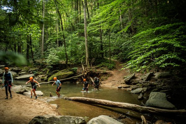 People enjoying an outdoor waterfall hiking adventure