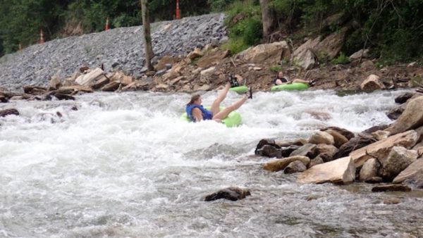 People enjoying Lower Green River tubing through scenic North Carolina scenery