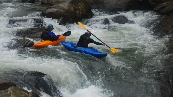 Couple enjoying a kayaking adventure together on a scenic river